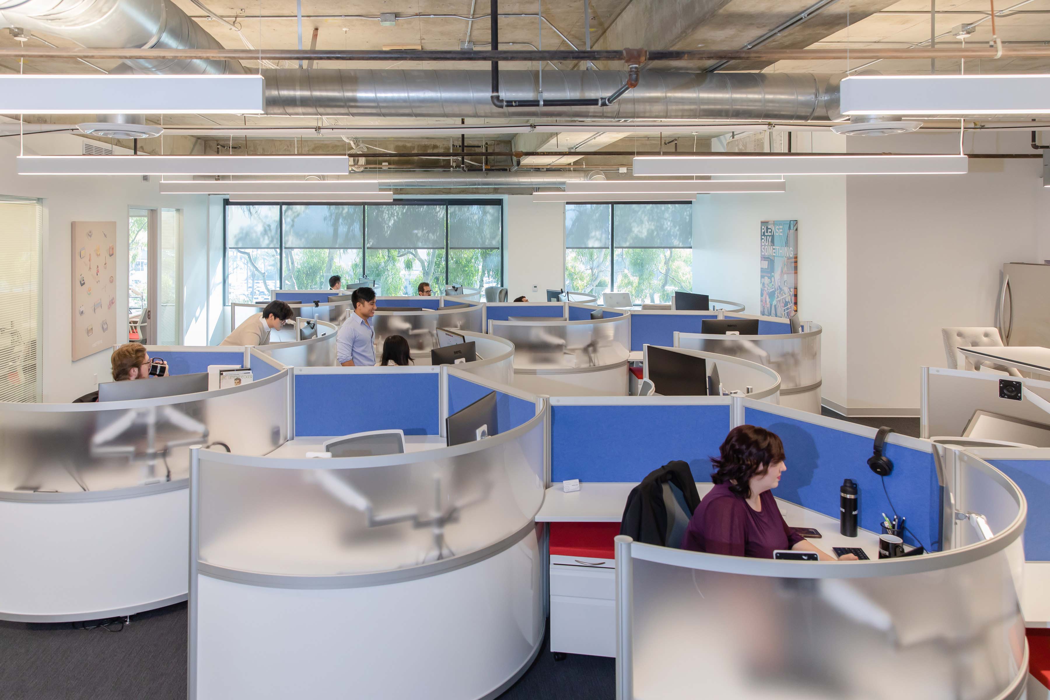 Airstrafe employees standing over a computer.